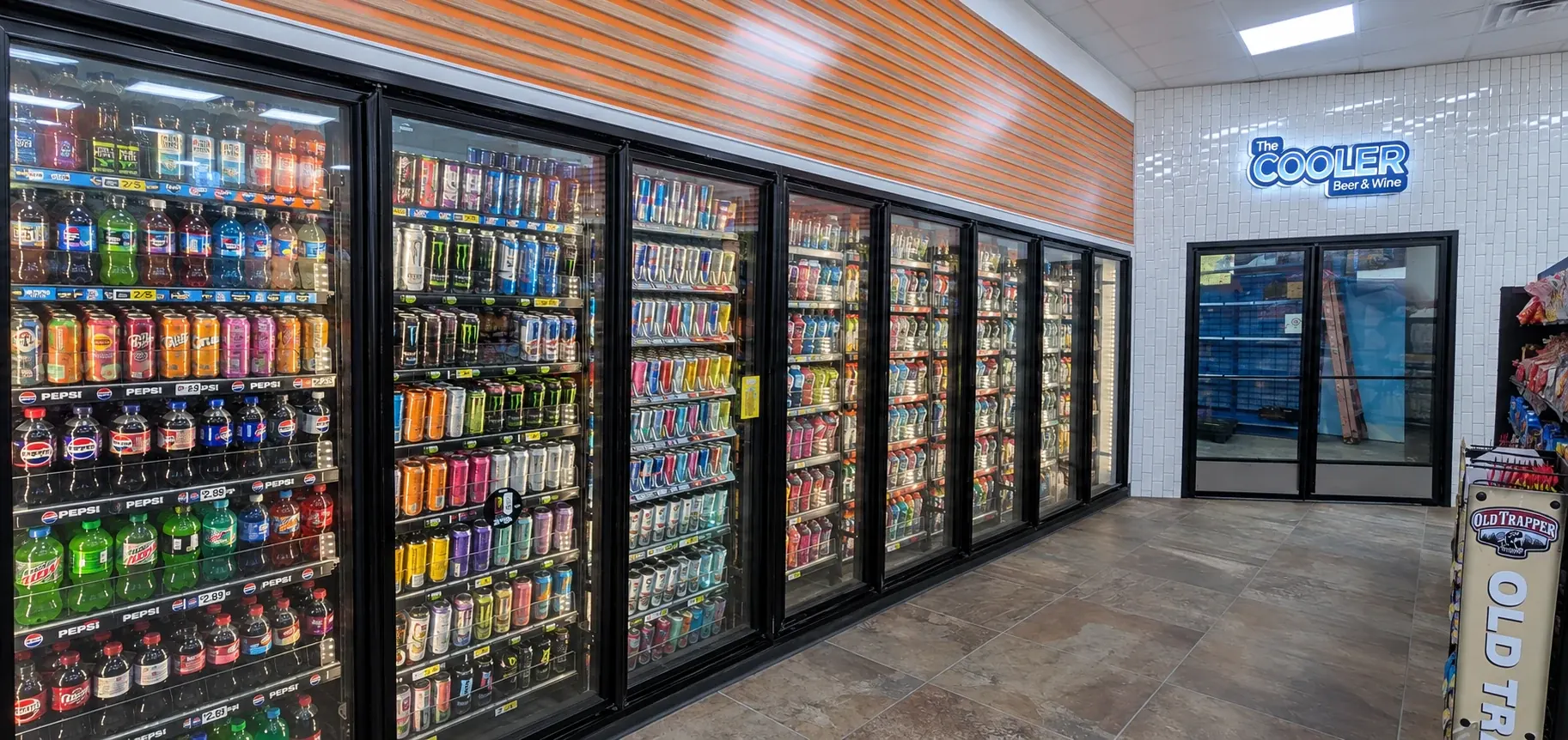 Beer and wine cooler aisle with stocked glass display doors and a double-door entrance