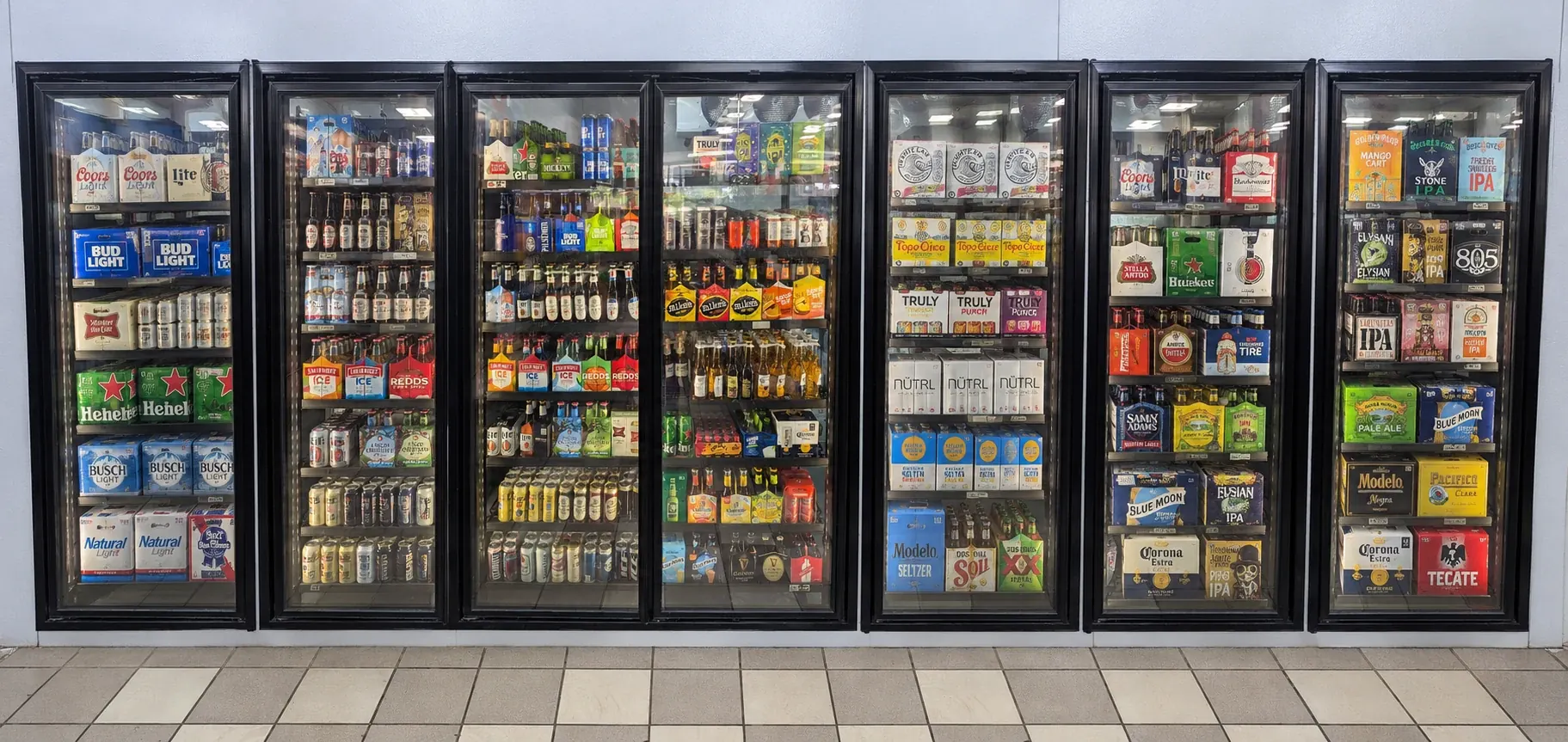 Tall narrow glass display doors showing refrigerated beer products
