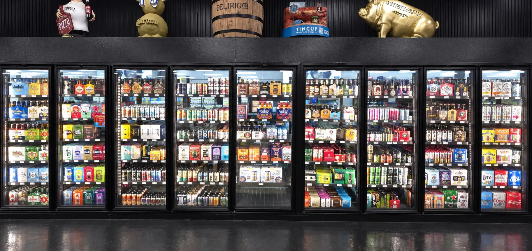 Wide glass-door cooler lineup stocked with beer