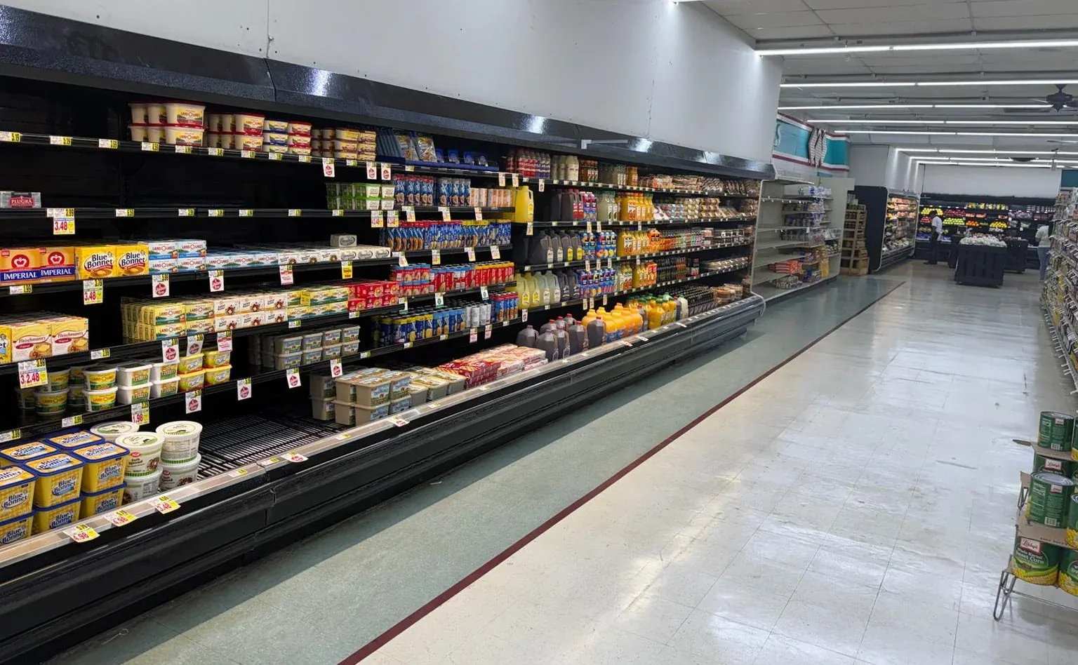 Aisle view of open refrigerated shelving