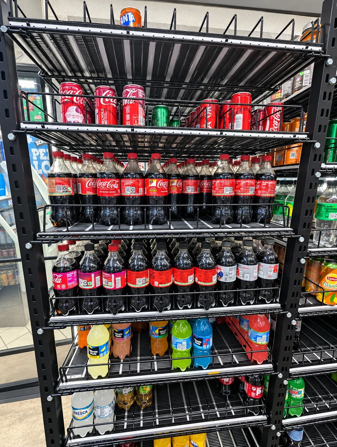 Front view of rolling shelves with drinks arranged in dedicated rows